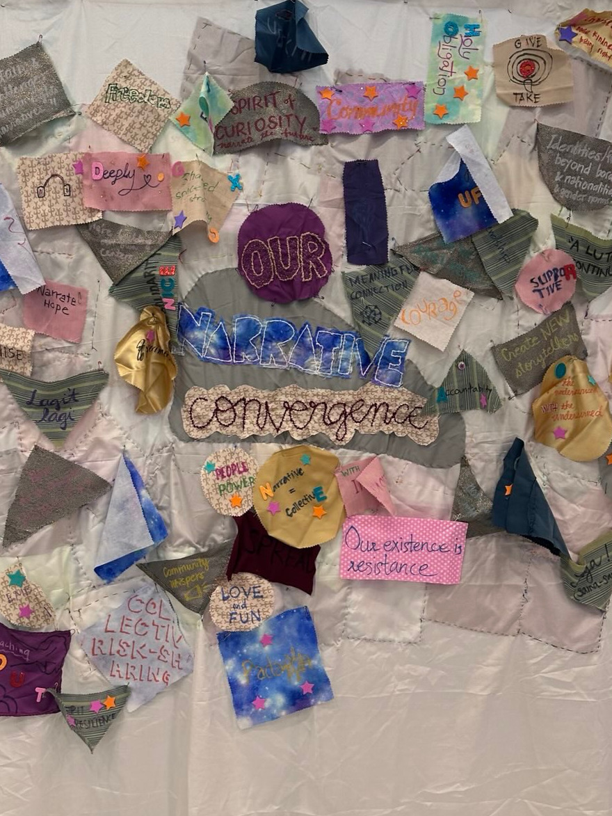 Community-made textile artwork spelling 'Our Narrative Convergence'